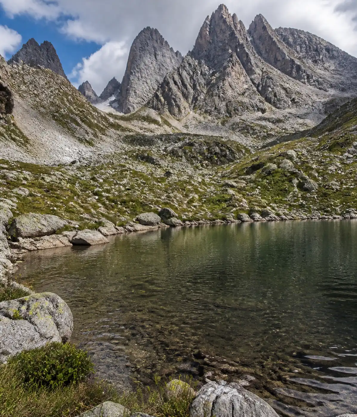 Alpine lake below the jagged peaks of the Chaukhi massif